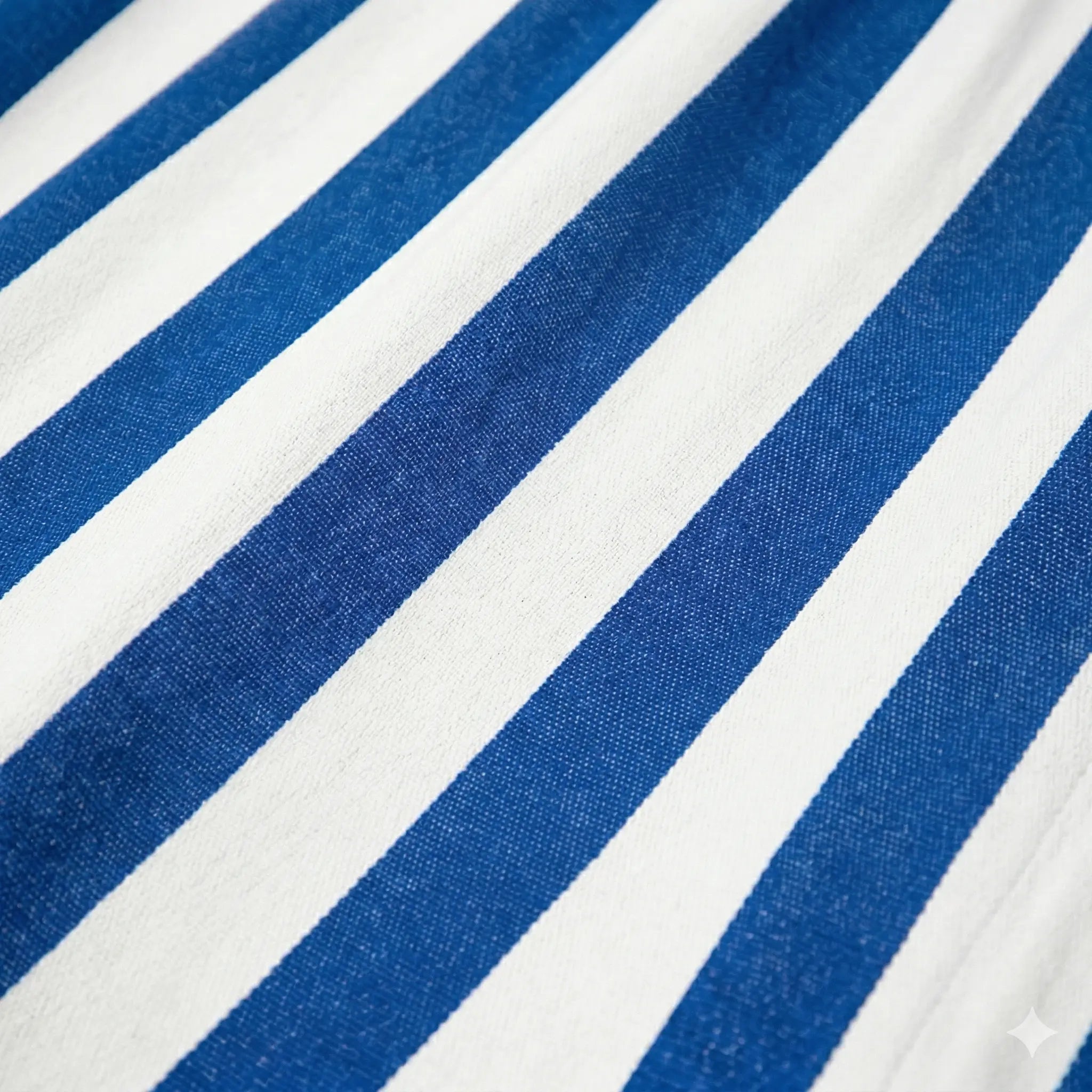 Gros plan sur la texture d'un tissu de hamac en toile de coton rayée bleu et blanc, montrant le tissage serré et durable.